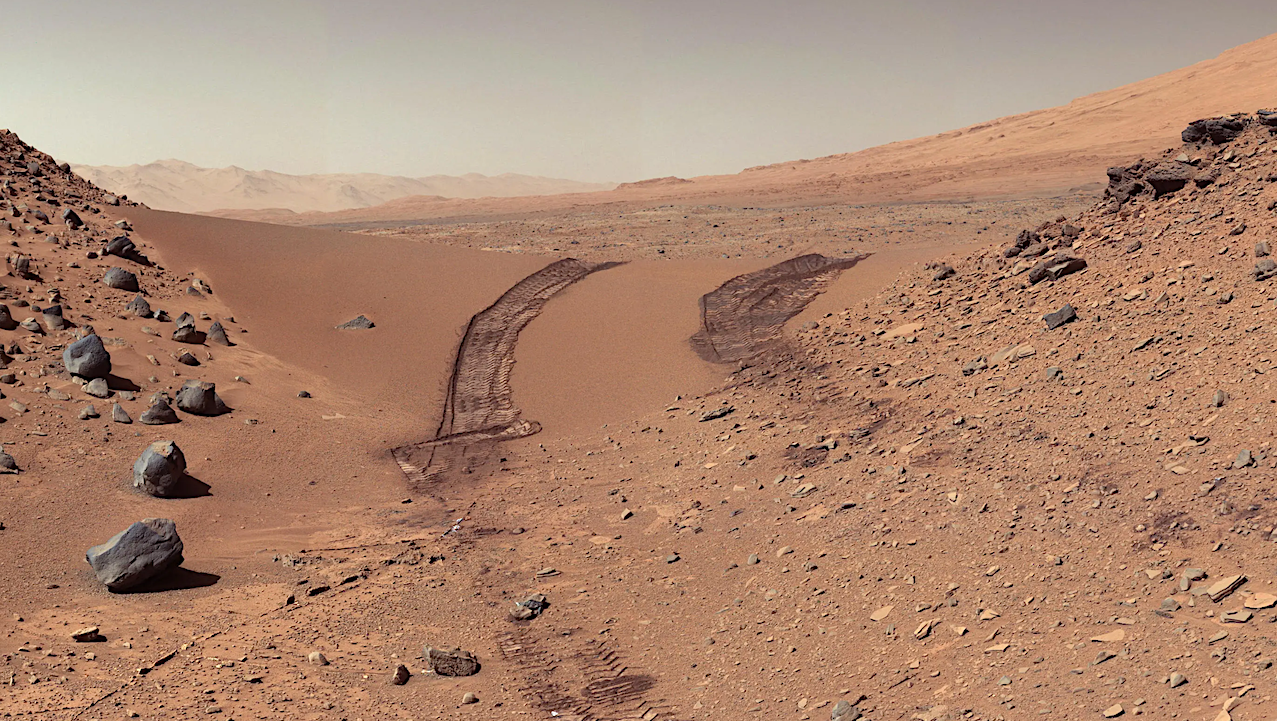 This look back at a dune that NASA's Curiosity Mars rover drove across was taken by the rover's Mast Camera (Mastcam) during the 538th Martian day, or sol, of Curiosity's work on Mars (Feb. 9, 2014). The rover had driven over the dune three days earlier. For scale, the distance between the parallel wheel tracks is about 9 feet (2.7 meters). The dune is about 3 feet (1 meter) tall in the middle of its span across an opening called "Dingo Gap." This view is looking eastward. Larger image