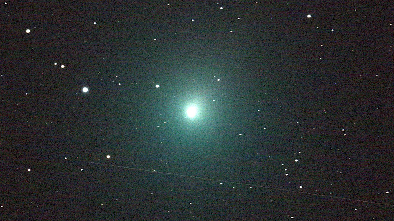 This 120 second image of the comet was taken Dec. 2 by an iTelescope 50 mm refractor located at an observatory near Mayhill, New Mexico. The streak below the comet was produced by a rocket body (upper stage) passing through the telescope's field of view during the exposure. Credit: NASA