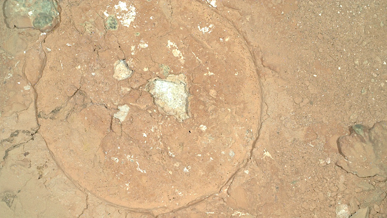 NASA's Mars Perseverance rover acquired this image, a nighttime mosaic of the Malgosa Crest abrasion patch at “Serpentine Rapids,” using its SHERLOC WATSON camera, located on the turret at the end of the rover's robotic arm. The diameter of the abrasion patch is 5 centimeters (about 2 inches) and the large green spot in the upper center left of the image is approximately 2 millimeters (about 0.08 inch) in diameter. Mosaic source images have been debayered, flat-fielded, and linearly color stretched. This image was acquired on Aug. 19, 2024 (sol 1243, or Martian day 1,243 of the Mars 2020 mission) at the local mean solar time of 19:45:30. NASA/JPL-Caltech Larger image
