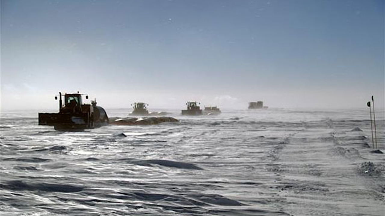 The South Pole Traverse crosses the polar plateau in December 2008. Using tractors and sleds to transport material and fuel overland has returned in full force, with the NSF purchasing an entire second train of vehicles and equipment with stimulus money. Photo Credit: Paul Thur/Antarctic Photo Library